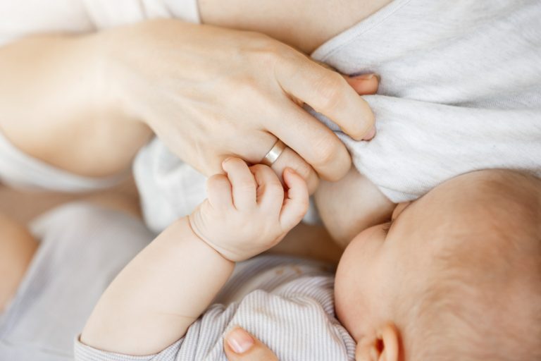close up intimate moment mother lactating her newborn son scene innocence protection family motherhood lifestyle concept