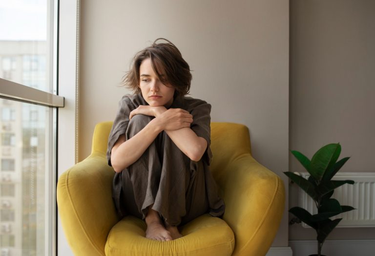 full shot woman with anxiety sitting chair